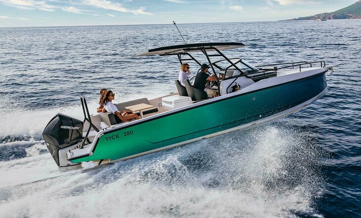 Green racing styled RYCK 280 moving at high speed on open water