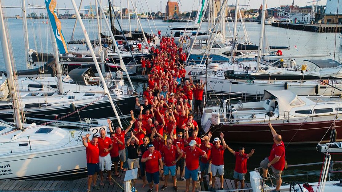 Regatta race members gather on a dock for a fun rally on the Baltic sea
