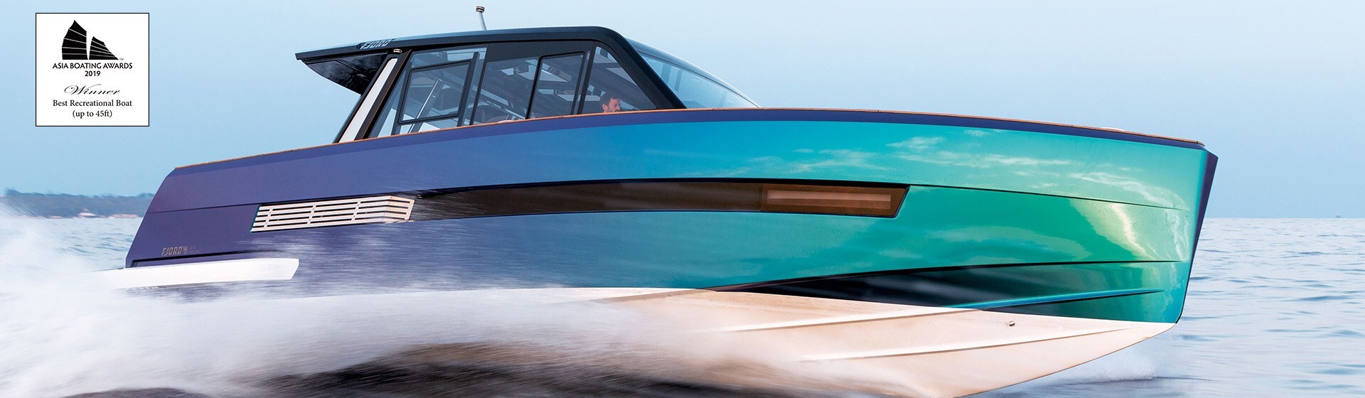 Majestic colored high-performance powerboat with deck cabin going fast