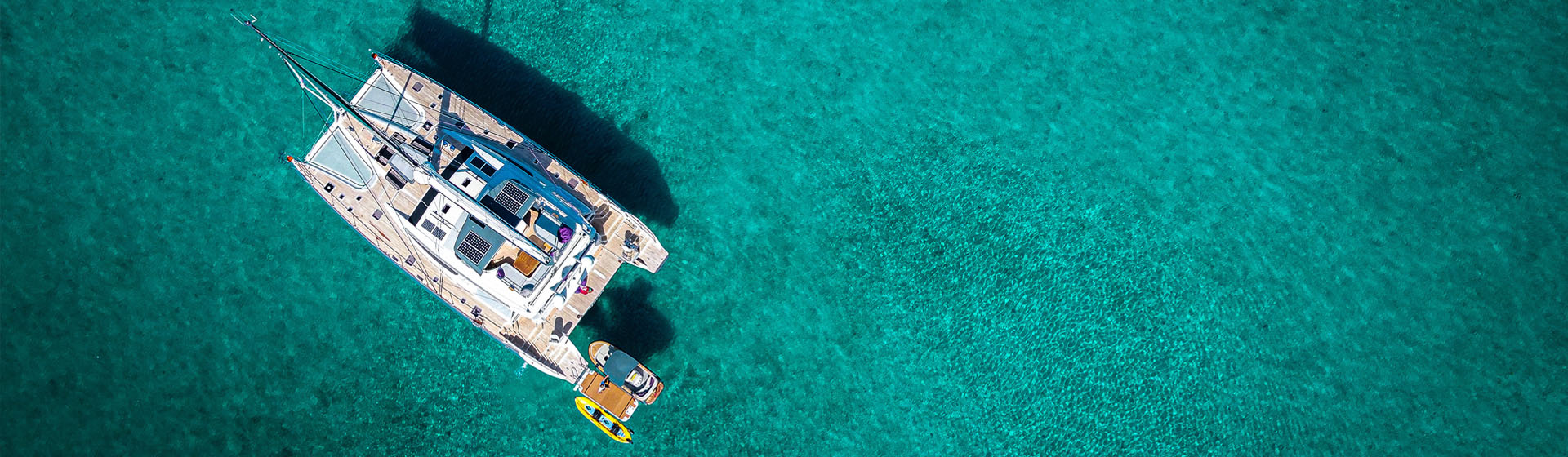 Vista aérea del catamarán de lujo Privilège Serie 740 en aguas tranquilas de color azul tropical