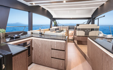 Sealine F430 galley | Stylish strips of lighting and high-gloss working surfaces create an aesthetic space in which you can conjure up meals with joy every time. | Sealine