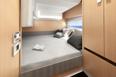 powerboat, cabin, interior, natural light, window, bed, berth, cupboard