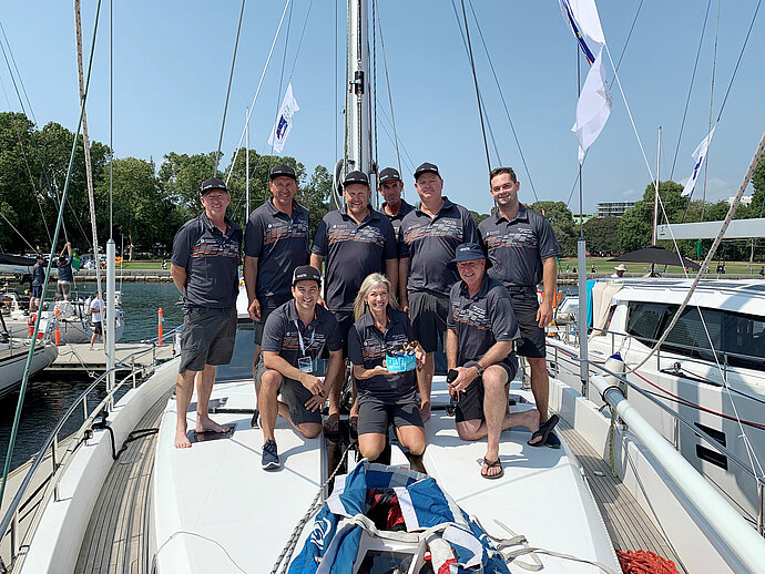 Crew of Moody 54 'Moody Buoys' poses on their yacht after second victory.