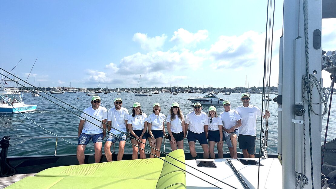 Yacht team gathered on deck post-race.